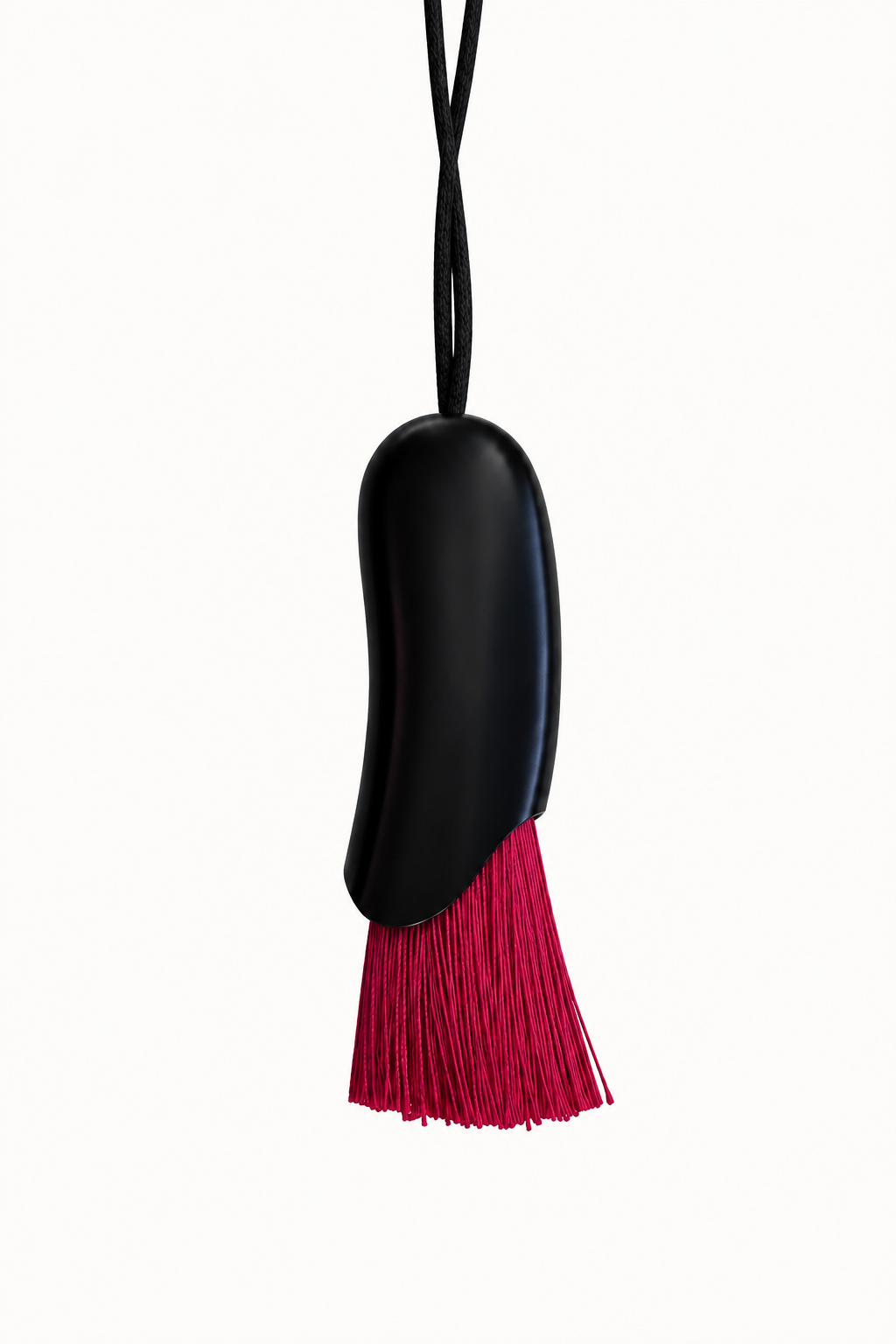 A black curved pendant with a vibrant magenta-pink tassel fringe, suspended from a thin black cord against a solid white background.